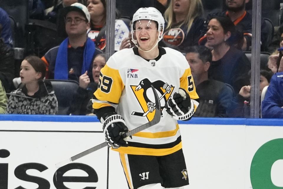 Pittsburgh Penguins' Jake Guentzel (59) smiles after scoring a goal against the New York Islanders during the second period of an NHL hockey game Wednesday, Dec. 27, 2023, in Elmont, N.Y. (AP Photo/Frank Franklin II)