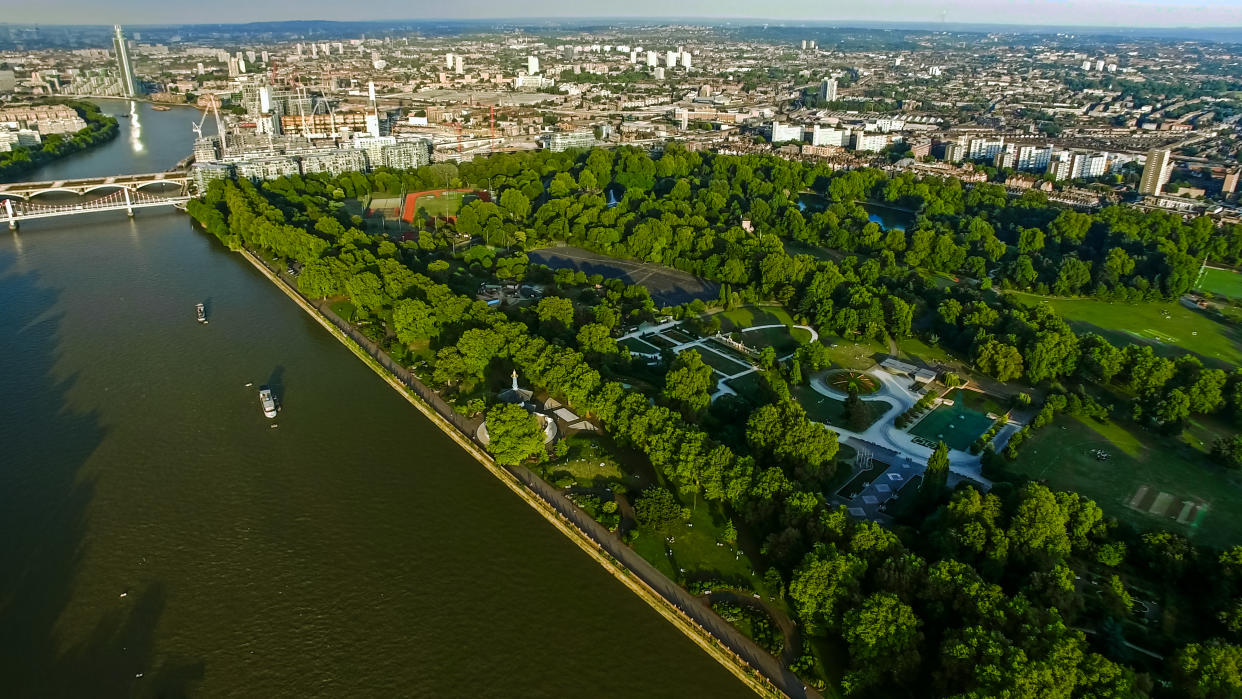 4K Aerial View Image Photo of Central London featuring the River Thames, Battersea Park and Chelsea Bridge in England UK