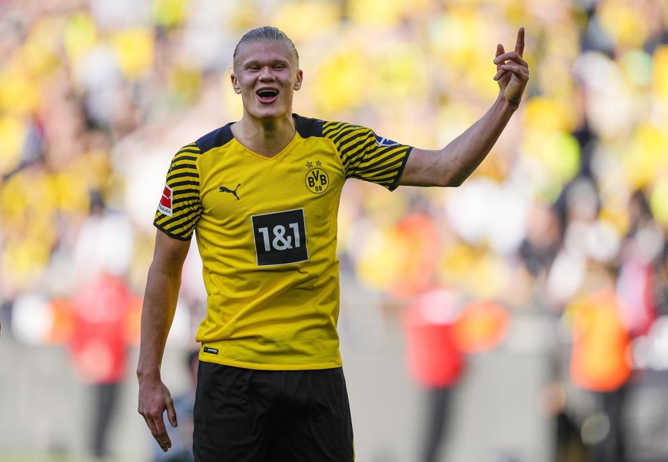 Dortmund's scorer Erling Haaland celebrates with fans after winning the German Bundesliga soccer match between Borussia Dortmund and VfL Wolfsburg in Dortmund, Germany, Saturday, April 16, 2022. (AP Photo/Martin Meissner)