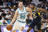 Charlotte Hornets forward Gordon Hayward (20) drives to the basket as Indiana Pacers forward Torrey Craig (13) defends during the first half of an NBA basketball game in Charlotte, N.C., Wednesday, Oct. 20, 2021. (AP Photo/Jacob Kupferman)