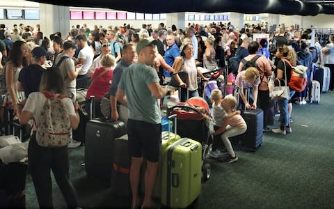 Departing passengers form a long queue to check in at Orlando International Airport ahead of the arrival of Hurricane Irma making landfall, in Florida - Credit: Reuters