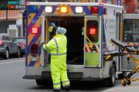 Worker sprays disinfectant in ambulance at Brooklyn Hospital Center during the coronavirus disease (COVID-19) in New York