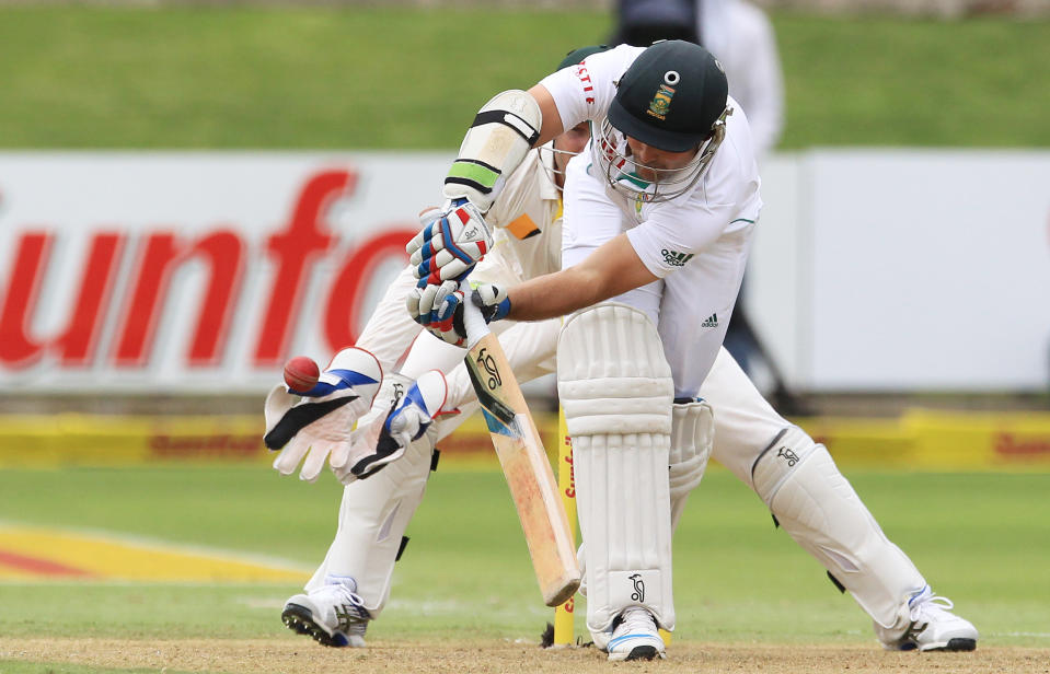 South Africa's batsman Dean Elgar, front, plays a ball as Australia's wicketkeeper Brad Haddin, rear, watches on the first day of their 2nd cricket test match at St George's Park in Port Elizabeth, South Africa, Thursday, Feb. 20, 2014. (AP Photo/ Themba Hadebe)