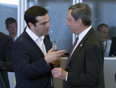 Greek Prime Minister Alexis Tsipras (L) talks with European Central Bank President Mario Draghi during a euro zone EU leaders emergency summit on the situation in Greece in Brussels, Belgium, July 7, 2015. REUTERS/Yves Herman