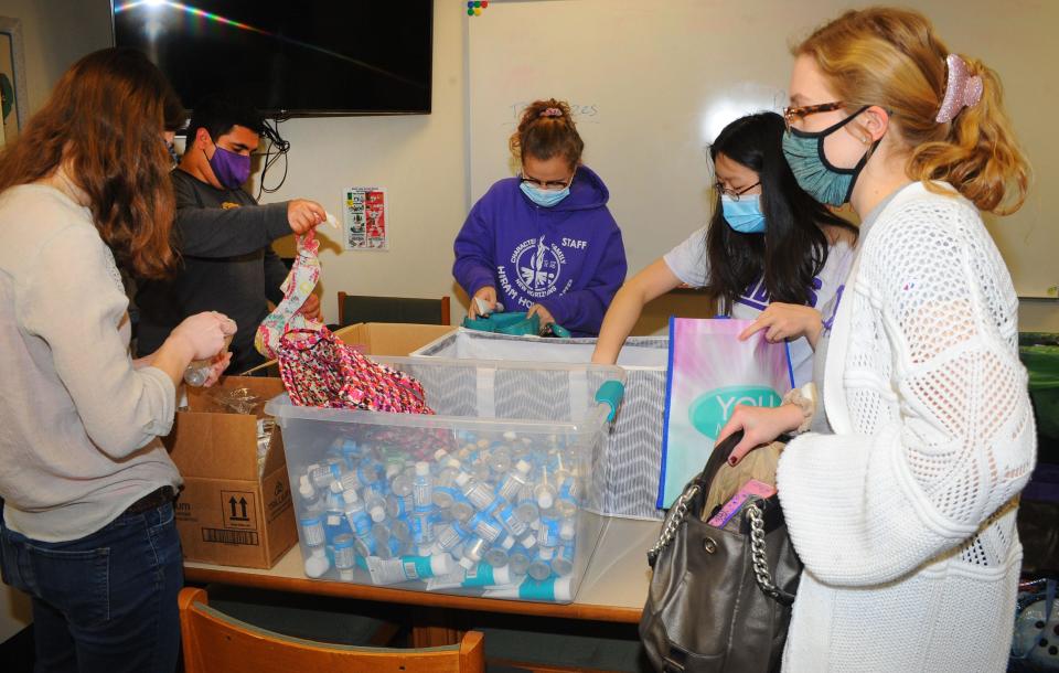 University of Mount Union students, from left, Dana Lucas, Jorge Tamariz, Ava Fornara, Chessie Misja and Allie Cox prepare carry-all bags containing personal care products for women in need on Saturday, Jan. 22, 2022. Volunteers from the university were on hand at various location throughout Alliance performing community service projects as a way of celebrating Martin Luther King Day. The events were rescheduled after heavy snow on the holiday.