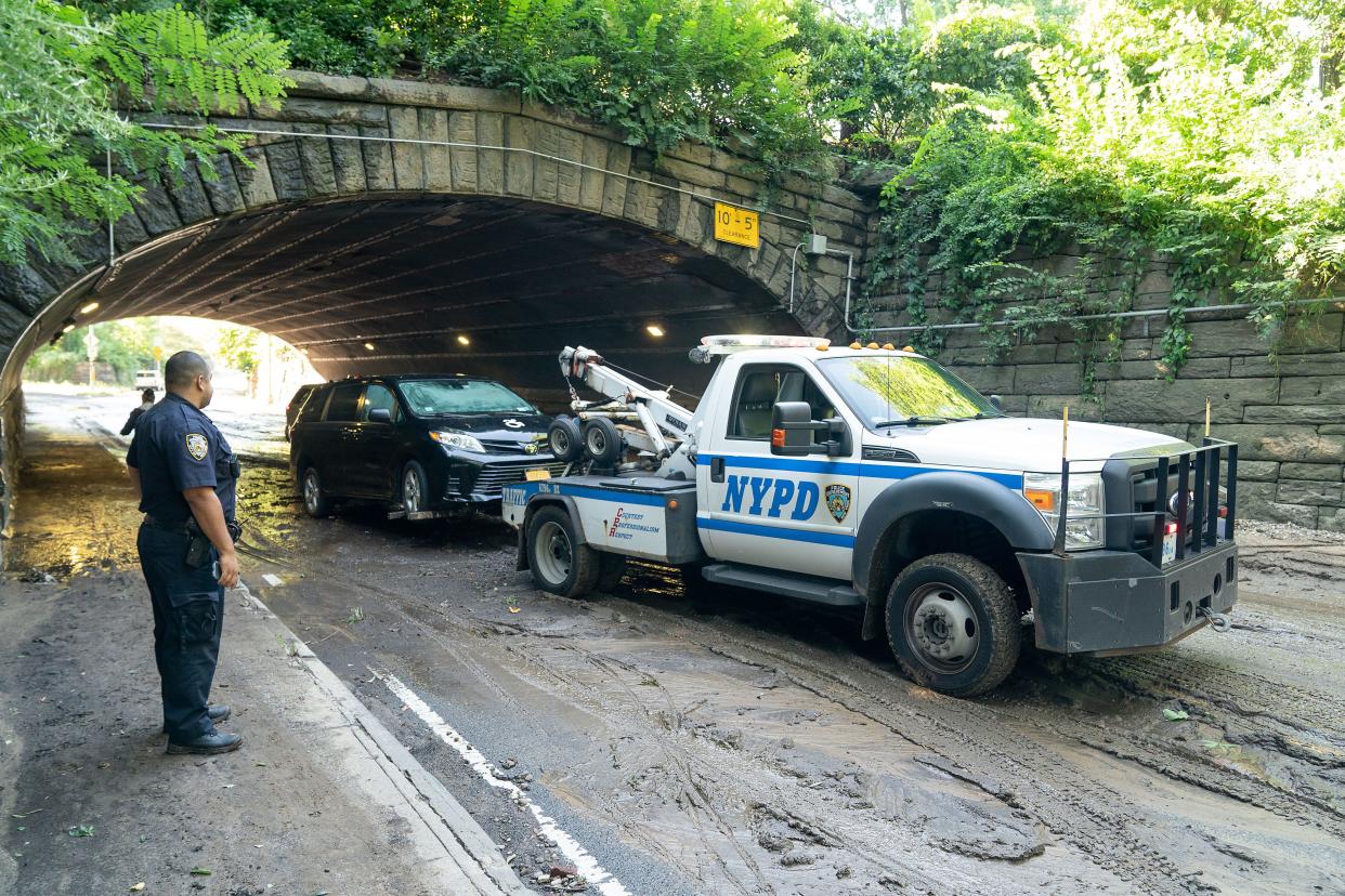 A flooded out and abandoned vehicle is towed by an NYPD tow truck on the 86th St. Transverse in Central Park on Thursday, Sept. 2, 2021.