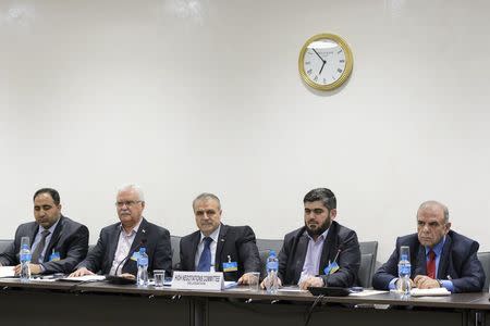 Members of the Syrian opposition delegation of the High Negotiations Committee (HNC) George Sabra (2nd L) delegation head Asaad Al-Zoubi (C) and Chief negotiator, Army of Islam rebel group's Mohammed Alloush (2nd R) attend a meeting with U.N. mediator on Syria Staffan de Mistura during Syria peace talks at the United Nations in Geneva, Switzerland, April 15, 2016. REUTERS/Fabrice Coffrini/Pool