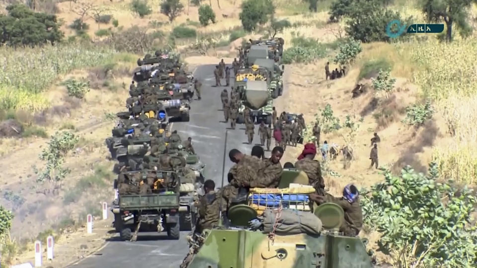 This image made from undated video released by the state-owned Ethiopian News Agency on Monday, Nov. 16, 2020 shows Ethiopian military gathered on a road in an area near the border of the Tigray and Amhara regions of Ethiopia. Ethiopia's prime minister Abiy Ahmed said in a social media post on Tuesday, Nov. 17, 2020 that "the final and crucial" military operation will launch in the coming days against the government of the country's rebellious northern Tigray region. (Ethiopian News Agency via AP)