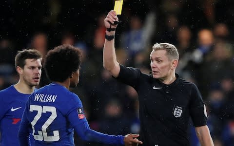 Willian is shown a yellow card for simulation by referee Graham Scott - Credit: Reuters