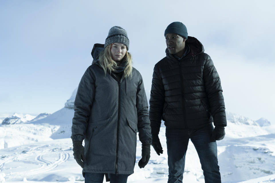 This image released by Quibi shows Sophie Turner, left, and Corey Hawkins in a scene from "Survive." Turner stars as a young woman with suicidal tendencies who survives a plane crash and fights to stay alive in a snowy wasteland alongside another passenger played by Hawkins. (Quibi via AP)