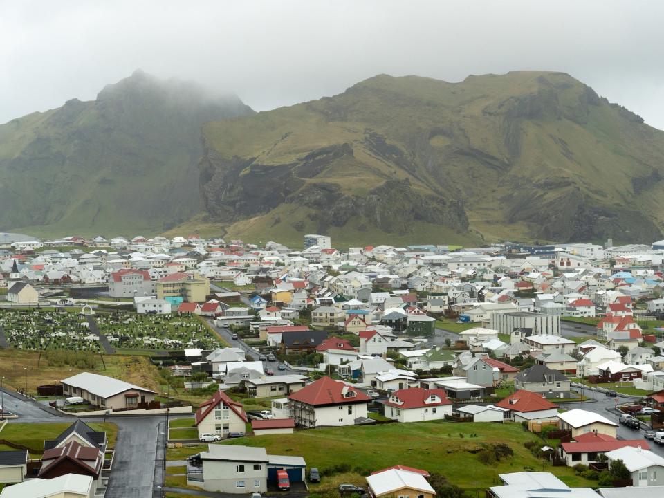 An aerial view of Town of Heimaey, Iceland, covered in fog.