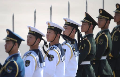 A Chinese military honor guard line up before Russian President Vladimir Putin's arrival at Beijing International Airport. China and Russia has pledged to increase their cooperation in the United Nations, as the giant neighbours try to resist mounting pressure for international action to stop the bloodshed in Syria