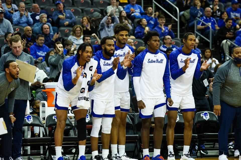 Members of Seton Hall's bench cheer on their teammates against Wagner