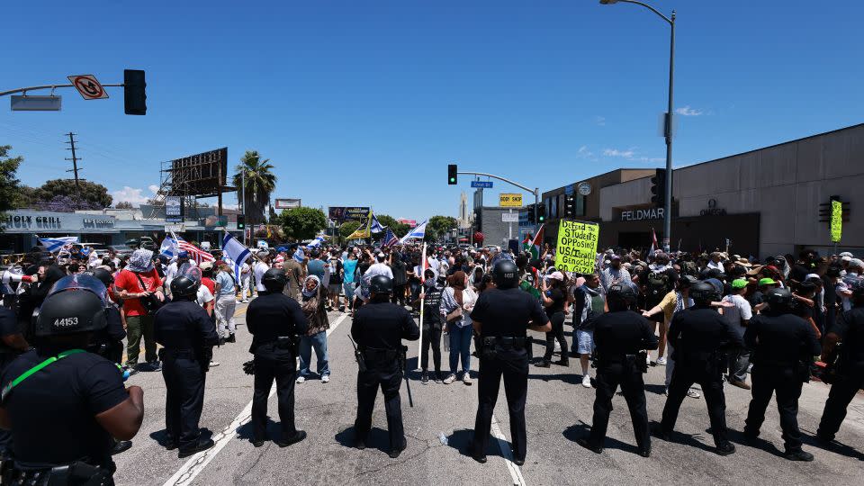 Los Angeles Police Department officers line up in front of pro-Palestinian protesters gathered outside the Adas Torah Orthodox Jewish synagogue in Los Angeles on Sunday. - David Swanson/AFP/Getty Images