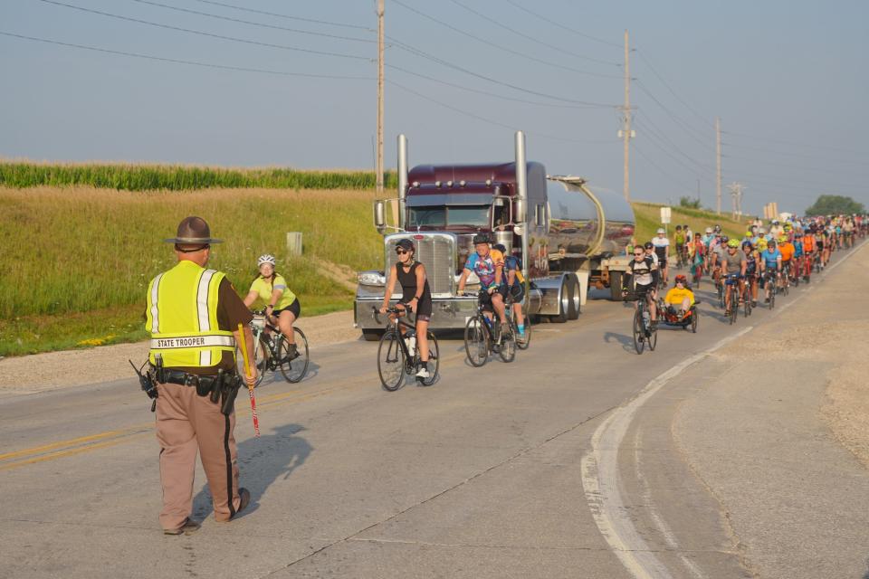 Iowa State Trooper Kevin Krull directs traffic Monday at an intersection near Storm Lake on RAGBRAI. “We’re here keeping the bikes and cars from mingling," he says.