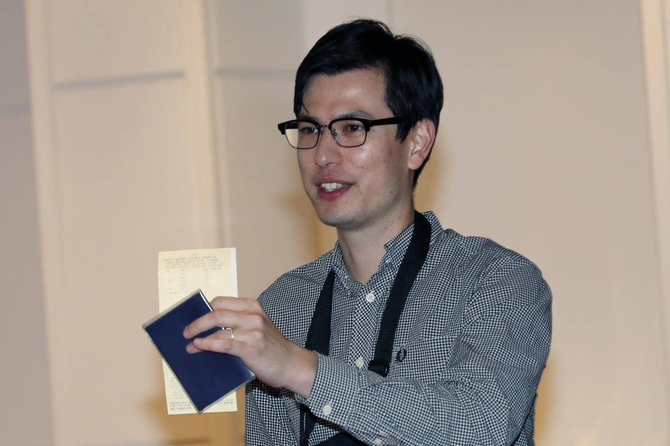 Australian student Alek Sigley gestures as he arrives at the airport in Tokyo on Thursday, July 4, 2019. The Australian student who vanished in North Korea more than a week ago arrived in Tokyo Thursday, July 4, 2019. (AP Photo/Eugene Hoshiko)