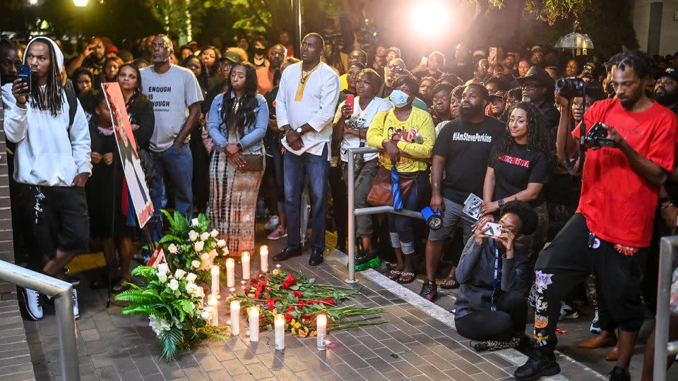 People attend a vigil for Stephen Perkins outside Decatur City Hall and Police Department on October 5. - Jeronimo Nisa/The Decatur Daily/AP/FILE