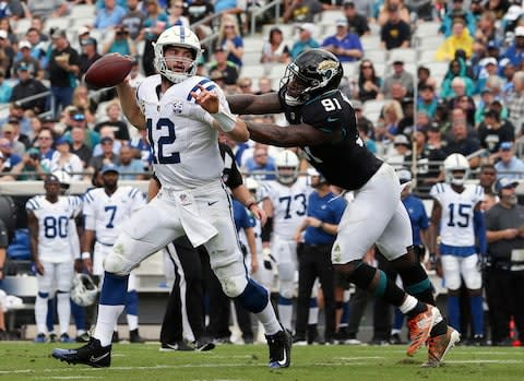 Indianapolis Colts quarterback Andrew Luck (12) scrambles away from Jacksonville Jaguars defensive end Yannick Ngakoue, right, during the first half of an NFL football game, Sunday - Credit: AP Photo/Gary McCullough