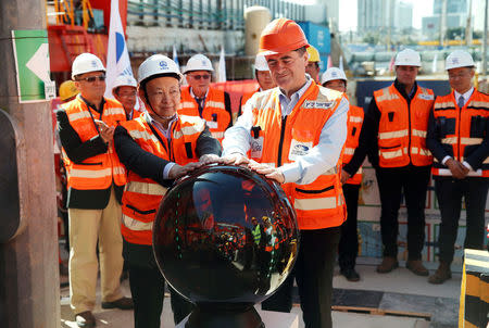 Yisrael Katz (front), Israel's Minister of Transport, and employees of China Railway Engineering Corporation, take part in an event marking the beginning of underground construction work of the light rail, using a Tunnel Boring Machine (TBM), in Tel Aviv, Israel February 19, 2017. Picture taken February 19, 2017. REUTERS/Baz Ratner