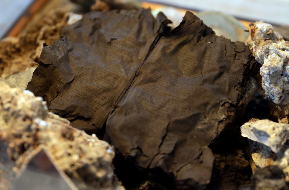 A charred bible that was found open to the passage Psalm 106, 107 on display at the Peshtigo Fire Museum on Sept. 28, 2021, in Peshtigo, Wis.