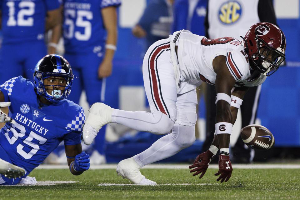 South Carolina defensive back David Spaulding (29) forces a fumble by Kentucky running back Sean O'Horo (35) on the first play from scrimmage of an NCAA college football game in Lexington, Ky., Saturday, Oct. 8, 2022. (AP Photo/Michael Clubb)