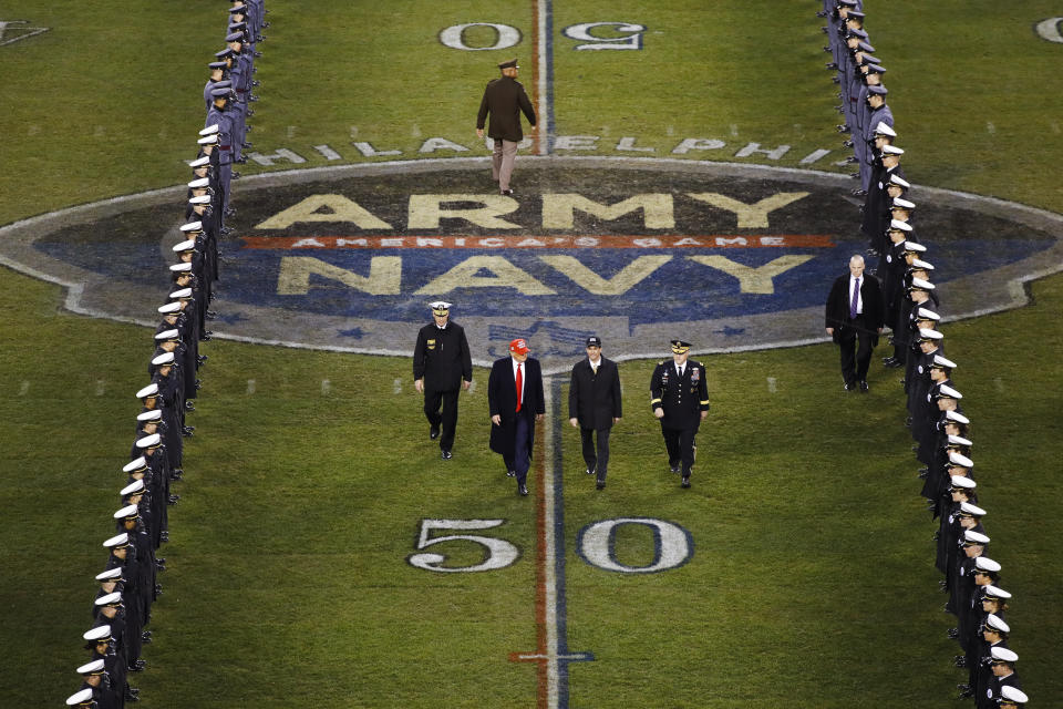 FILE - President Donald Trump and Secretary of Defense Mark Esper cross the field after the first half of an NCAA college football game between Army and Navy in Philadelphia, in this Saturday, Dec. 14, 2019, in file photo. Bump Army-Navy or go head-to-head with NFL? That's the choice facing those in charge with expanding the College Football Playoff if they want to take the format from four to 12 teams. (AP Photo/Matt Rourke, File)