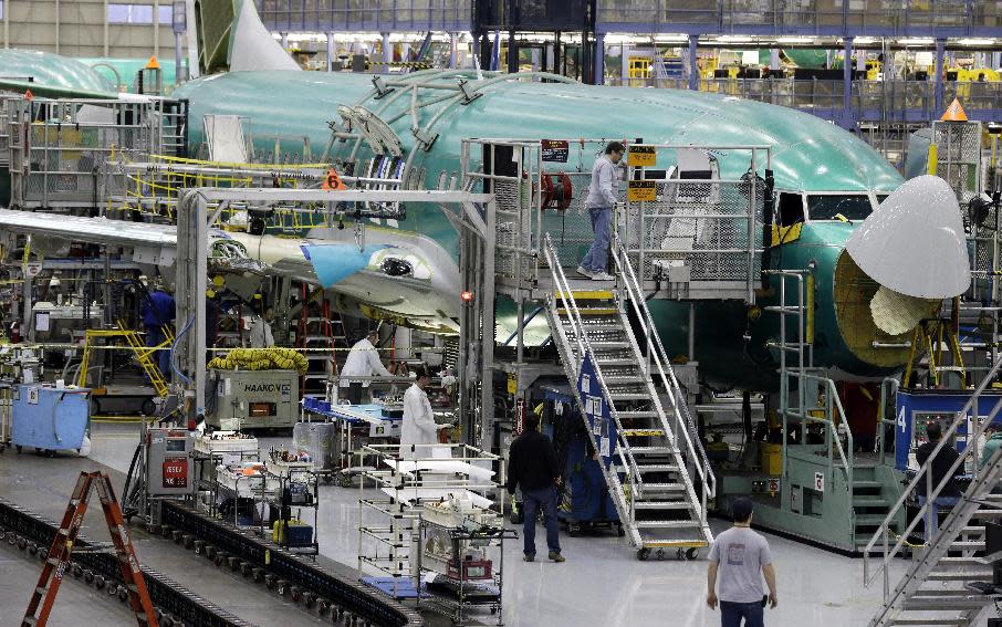 Workers assemble a Boeing Co. next-generation 737 airplane, Tuesday, Jan. 29, 2013 at the company's 737 assembly facility in Renton, Wash. On Jan. 25, 2013, Boeing began assembling next-generation 737 passenger airplanes at an increased rate of 38 planes per month. (AP Photo/Ted S. Warren)