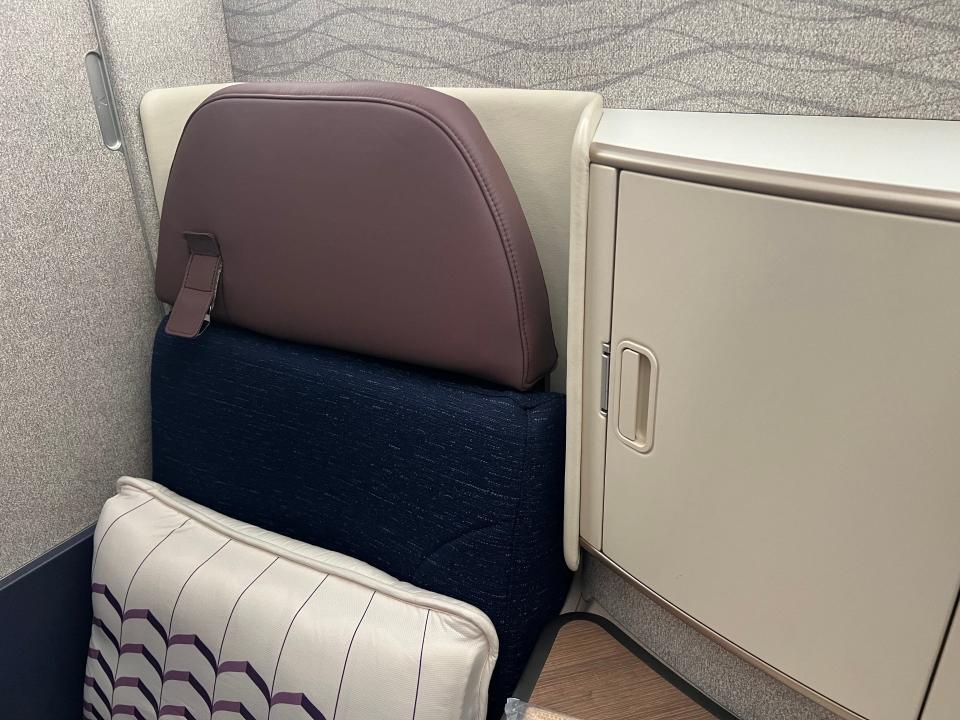 The business class seat on Air India features blues and purples.