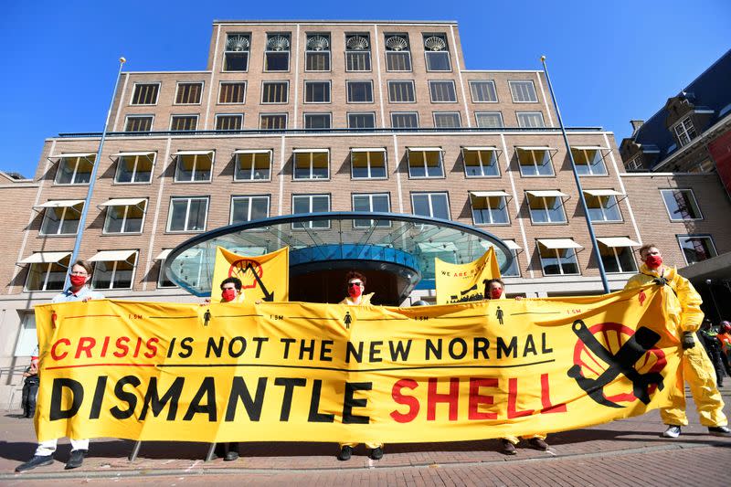 Protesters shout during a demonstration outside of the Shell headquarters, in The Hague