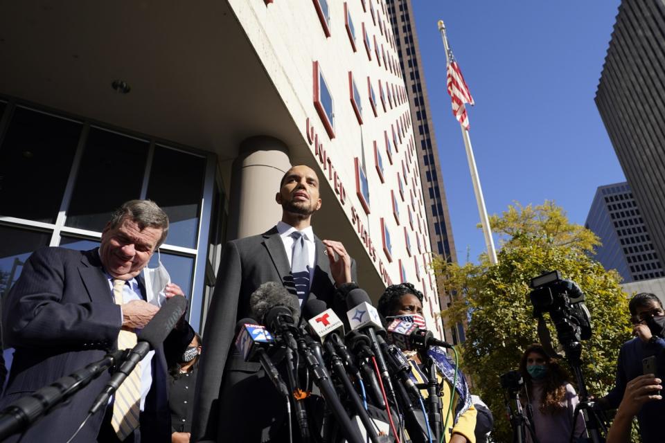 Harris County Clerk Chris Hollins speaks outside the federal courthouse after a hearing in Houston.