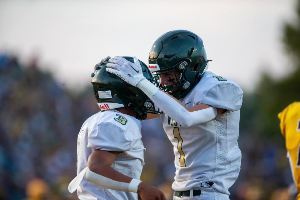 Zeeland West's Rolando Robelin (3) celebrates a touchdown with Zeeland West's Keaton Hendricks (1) Friday, Sept. 22, 2023, at Zeeland Stadium.