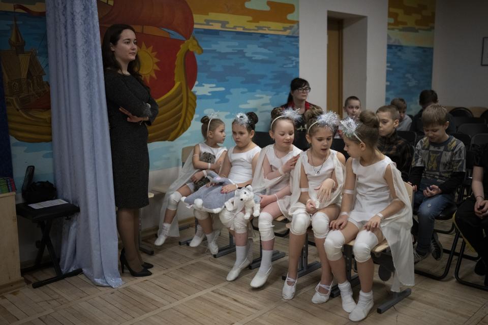 Children from the Barentsburg's school wait in Barentsburg, Norway, Saturday, Jan. 7, 2023, to see a performance by members of Polargospel, the children's choir at the only church in Svalbard. The children traveled three hours each way by boat to mark Orthodox Christmas with the 40 children in Barentsburg, a village owned by Russia's Arctic mining company in the remote Norwegian territory. (AP Photo/Daniel Cole)