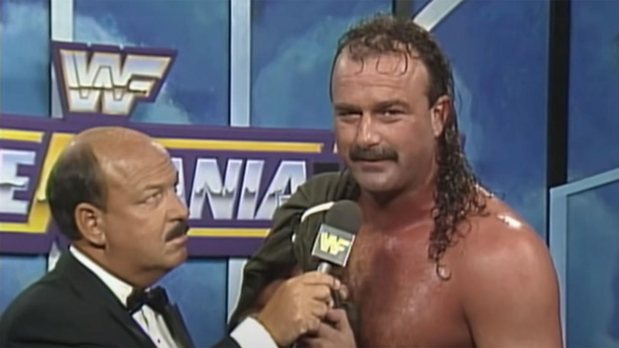  Jake Roberts giving a promo alongside Mean Gene. 