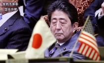 A TV shows Japanese Prime Minister Shinzo Abe listening to a question at Diet session, at a foreign exchange brokerage in Tokyo, Wednesday, Feb. 1, 2017. Japanese officials have rejected U.S. President Donald Trump's suggestion that Tokyo is seeking to weaken the yen against the U.S. dollar to gain a trade advantage. (AP Photo/Shizuo Kambayashi)