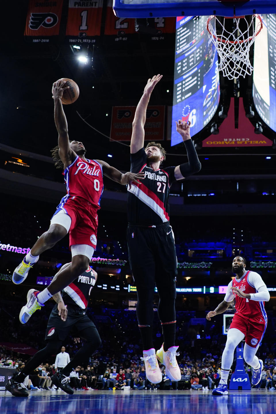 Philadelphia 76ers' Tyrese Maxey (0) goes up for a shot against Portland Trail Blazers' Jusuf Nurkic (27) during the first half of an NBA basketball game, Monday, Nov. 1, 2021, in Philadelphia. (AP Photo/Matt Slocum)