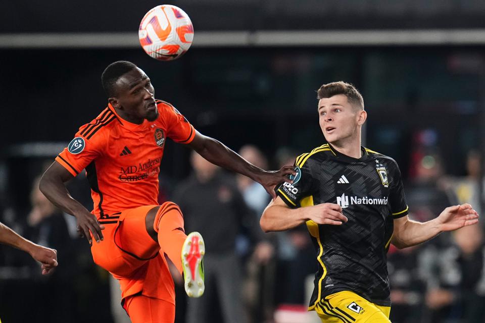 Mar 12, 2024; Columbus, OH, USA; Houston Dynamo forward Ibrahim Aliyu (18) heads the ball over Columbus Crew midfielder Sean Zawadzki (25) during the second half of the Concacaf Champions Cup soccer game at Lower.com Field. Mandatory Credit: Adam Cairns-USA TODAY Sports
