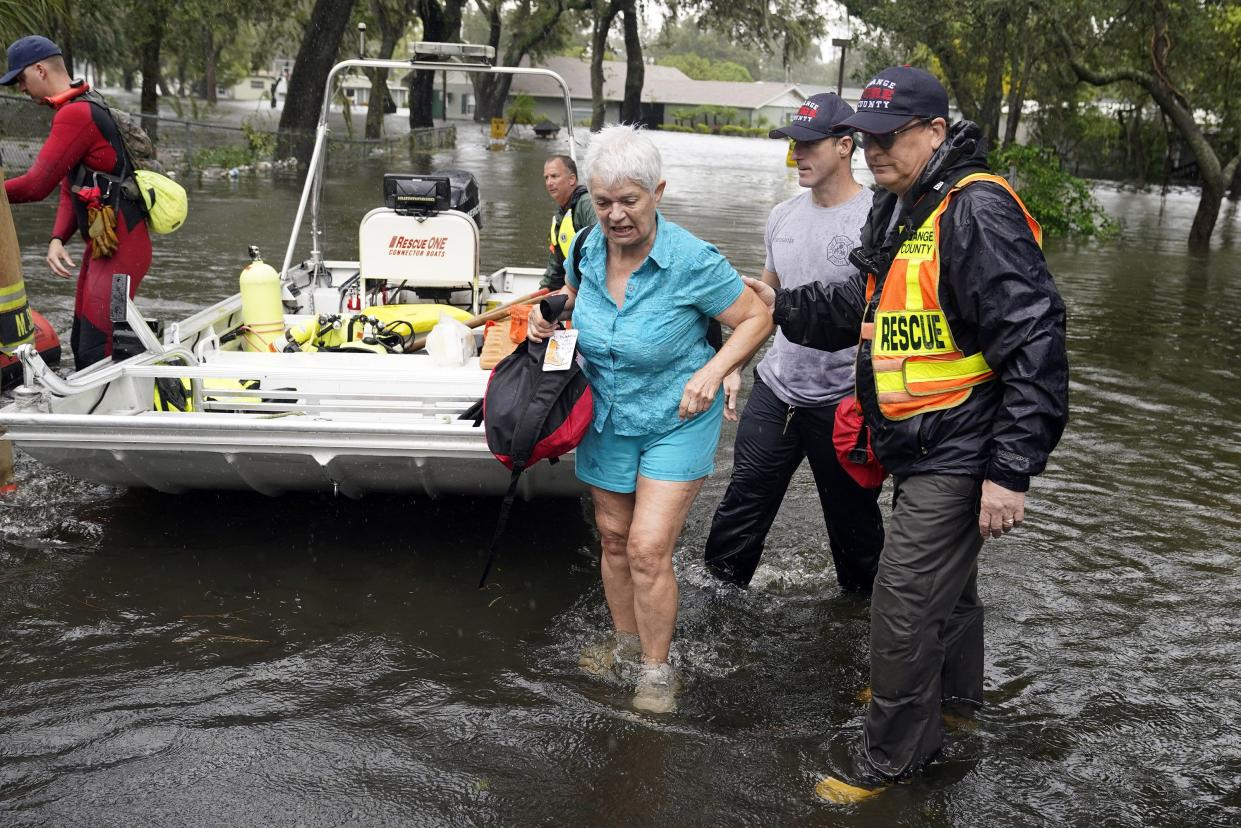 A resident in an Orlando, Fla., neighborhood is rescued from floodwaters in the aftermath of Hurricane Ian, Thursday, Sept. 29, 2022.