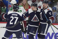 Colorado Avalanche left wing Artturi Lehkonen, center, is congratulated after scoring a goal by left wing Jonathan Drouin (27) and right wing Valeri Nichushkin (13) in the second period of an NHL hockey game Sunday, April 7, 2024, in Denver. (AP Photo/David Zalubowski)