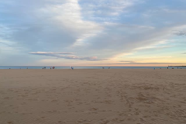 <p>Rachel Chang/Travel + Leisure</p> Sunset over a sandy beach in Valencia, Spain