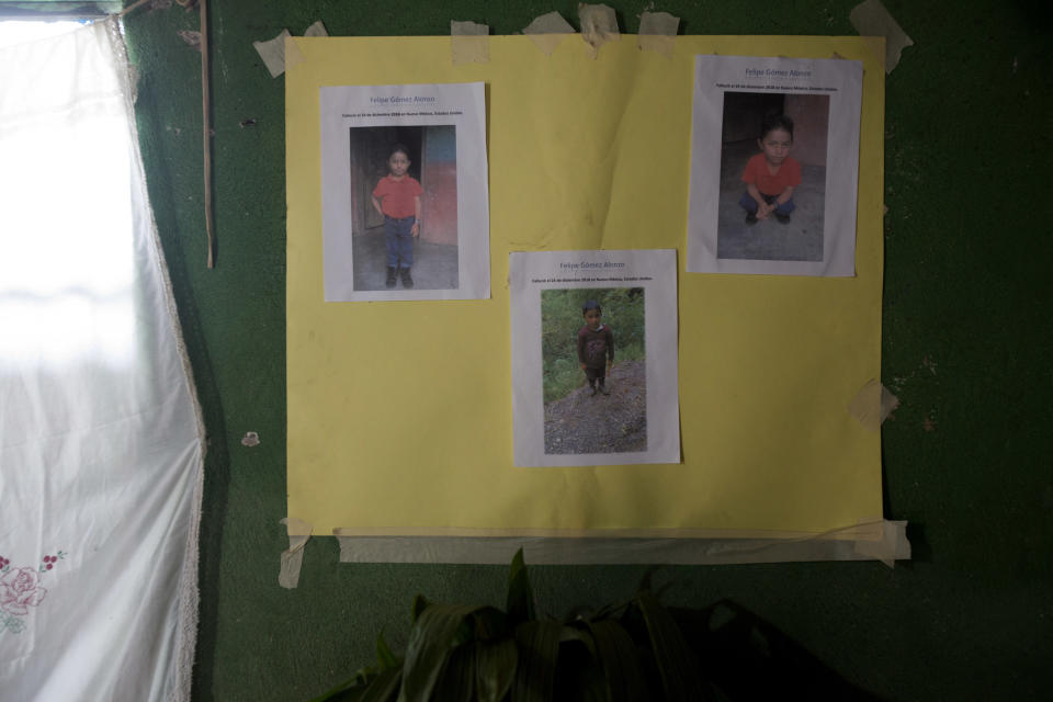 A poster with photo copies that show Felipe Gomez Alonzo is taped to a wall as part of a makeshift altar honoring the 8-year-old, inside his mother's home in Yalambojoch, Guatemala, Saturday, Dec. 29, 2018. On Christmas Eve, Felipe became the second Guatemalan child this month to die while in U.S. custody near the Mexican border. (AP Photo/Moises Castillo)