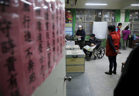 Voters cast their ballots at a polling station during general elections in Taipei, Taiwan January 16, 2016. REUTERS/Damir Sagolj