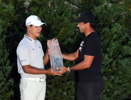 May 14, 2017; Ponte Vedra Beach, FL, USA; 2016 past champion Jason Day (right) hand off the trophy to Si Woo Kim after winning The Players Championship golf tournament at TPC Sawgrass - Stadium Course. Mandatory Credit: Mandatory Credit: Michael Madrid-USA TODAY Sports