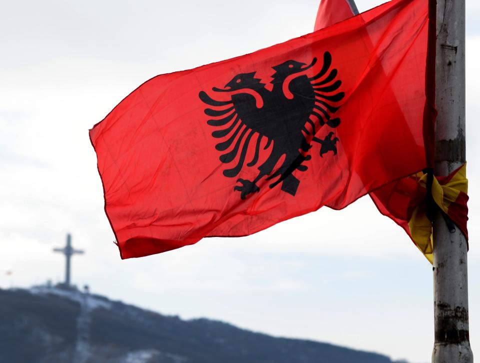 The flag of Albania is seen during the traditional dance performing of the members of the ethnic Albanian minority in Macedonia with traditional dresses, as they celebrate the National Albanian Flag Day and the anniversary of Albania’s Independence, in Skopje, Macedonia on November 28, 2017. The Macedonian Albanian community, which makes up for around 25 percent of the 2.1 million population of Macedonia, are the biggest ethnic minority in the country. (Getty Images)