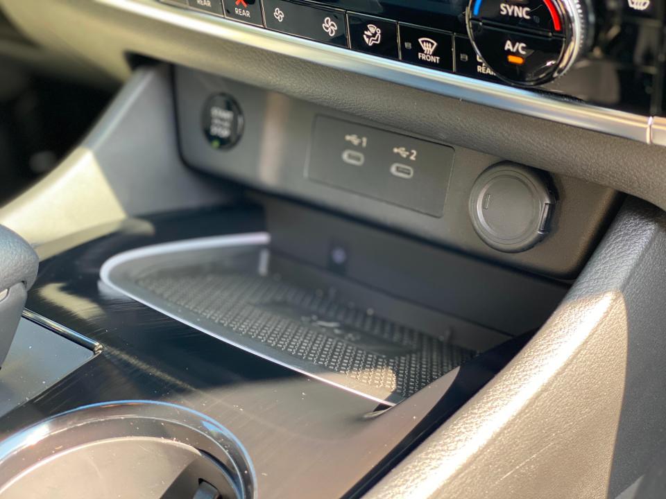 The USB plugs and wireless charging pad in the front dash of a 2024 Nissan Rogue SL SUV.