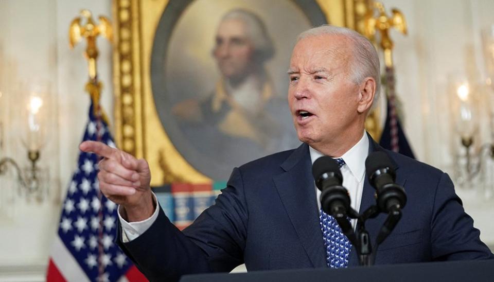 Joe Biden gestures as he speaks at the White House on February 8
