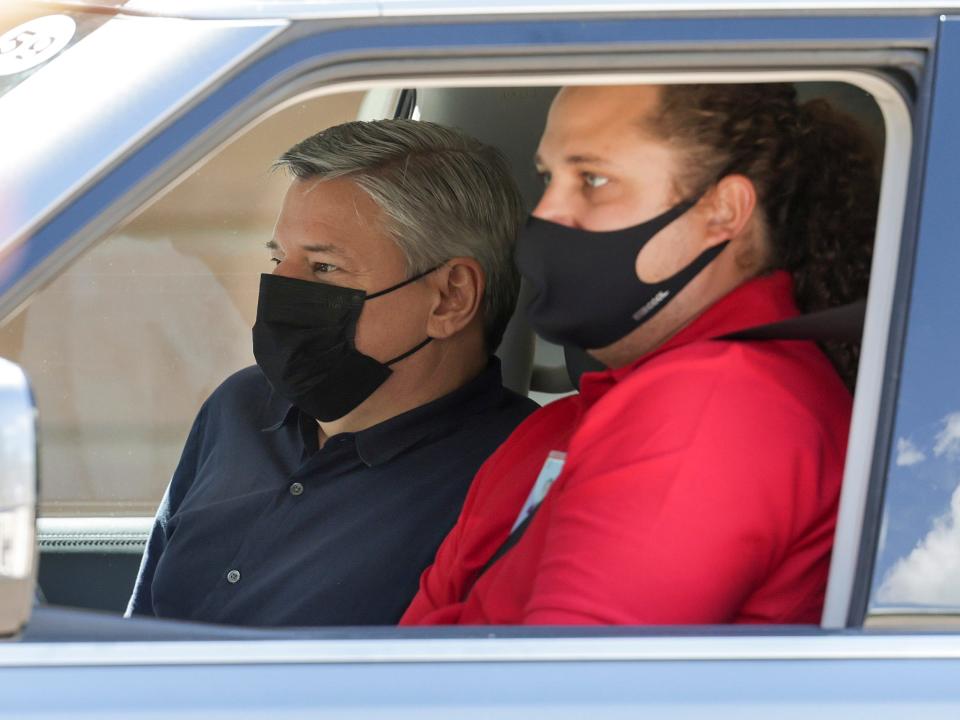 Ted Sarandos rides in passenger seat next to driver of car arriving at Sun Valley