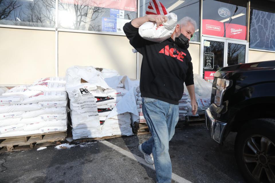 Bags of salt and calcium chloride in front of Anchor Ace Hardware in Denville. Employee, Bill Prentiss carries a bag of calcium chloride, used for melting ice as the Morris County area prepares for potential snow tomorrow.