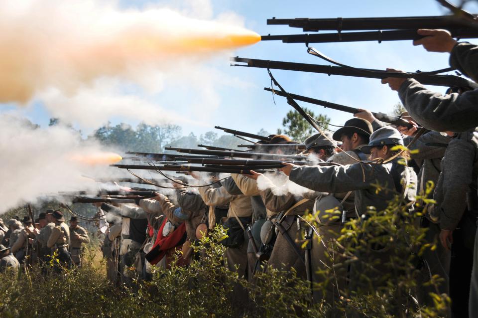 Historical re-enactors dressed as Confederate soldiers fire on Union forces during the re-enactment of the Battle of Olustee, which is scheduled for February.