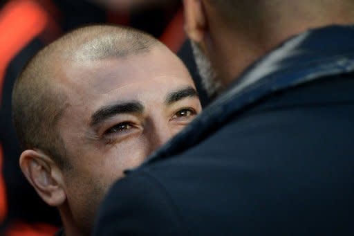 Chelsea's Italian interim manager Roberto Di Matteo (L) greets Barcelona's Spanish manager Josep Guardiola (R) ahead of the UEFA Champions League semi-final first leg football match at Stamford Bridge in London. Chelsea won 1-0