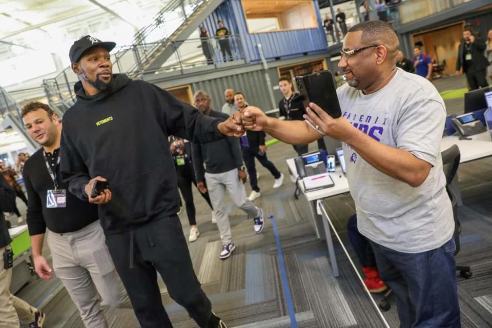 Kevin Durant fist bumps a United Wholesale Mortgage team member on Oct. 9, 2023, in Pontiac, Michigan.